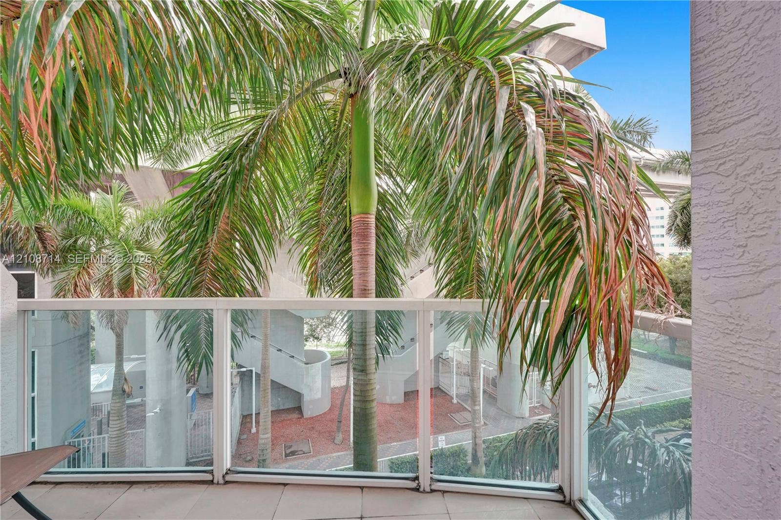 41 SE 5th Street, #317, Miami, Miami, FL 33131 Covered balcony featuring tile flooring and a glass-paneled railing