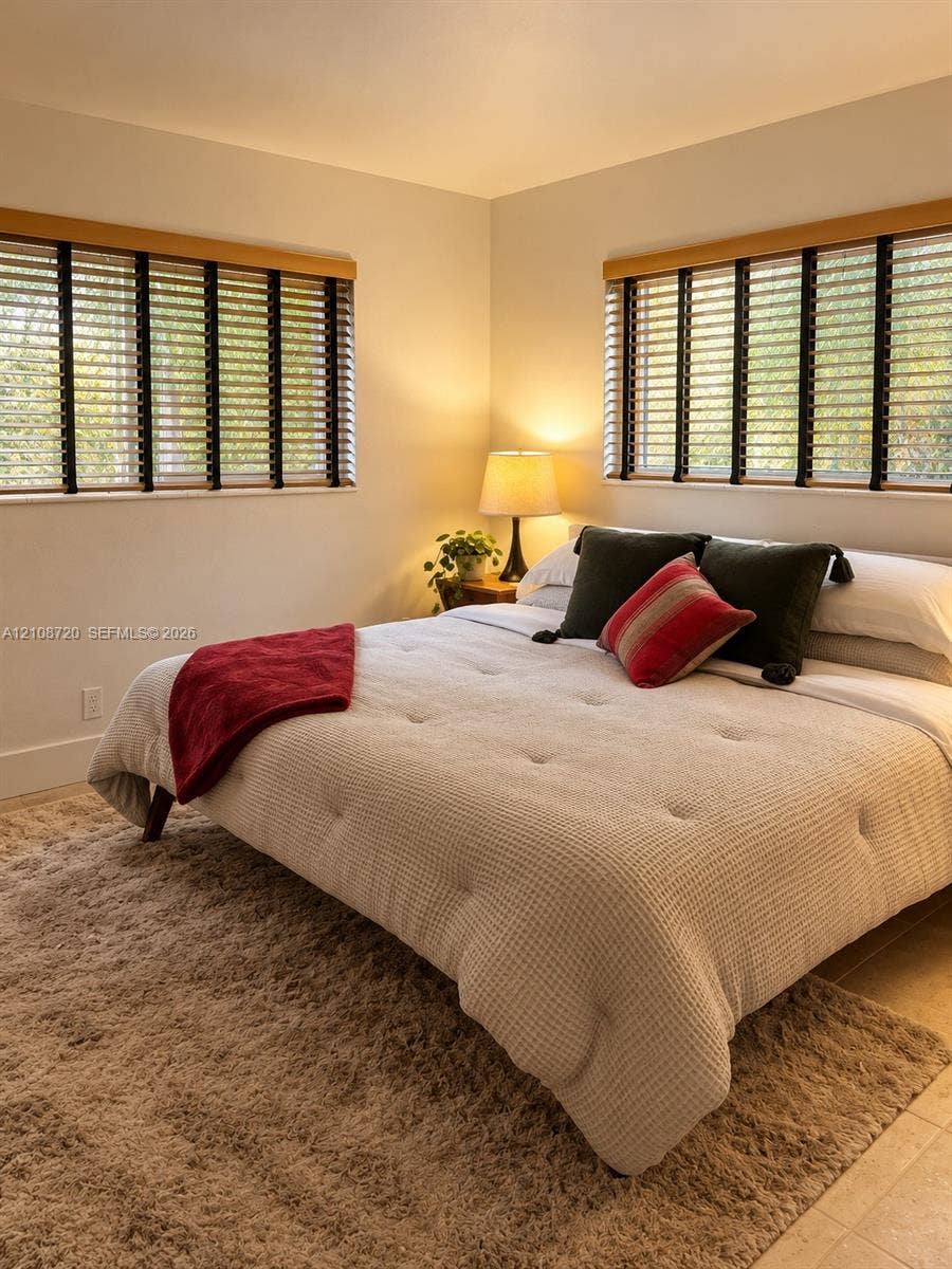 2404 NE 33rd Avenue, #3, Fort Lauderdale, FL 33305 Neutral wall tones complemented by dual windows featuring wood-finish trim and horizontal window blinds