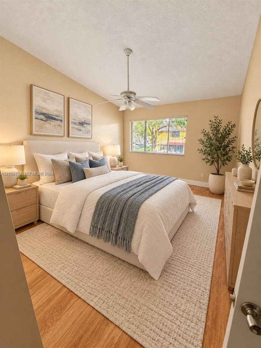 972 NW 92nd Terrace, Plantation, Plantation, FL 33324 Room featuring wood-finish flooring, a multi-blade ceiling fan with integrated lighting, and a large window