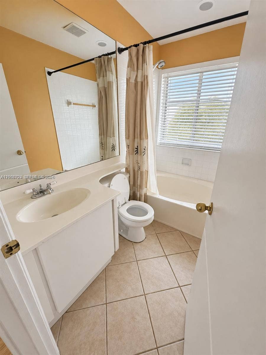 972 NW 92nd Terrace, Plantation, Plantation, FL 33324 Bathroom featuring a vanity with an integrated countertop sink, a full-width wall mirror, a ceramic tile bathtub surround, and diagonal-set floor tiling