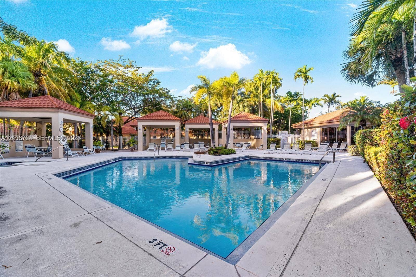 972 NW 92nd Terrace, Plantation, Plantation, FL 33324 Swimming pool area with concrete decking, tile-roofed cabanas, and established palm trees