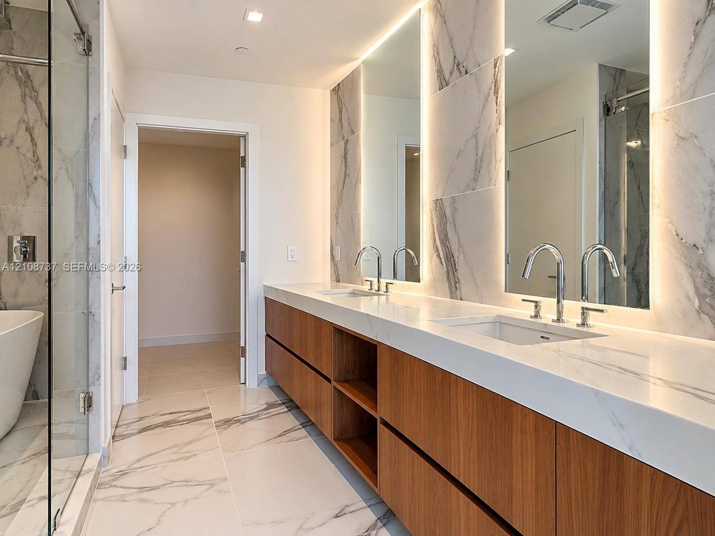 1400 Biscayne Boulevard, #3503, Miami, Miami, FL 33132 Floating wood-finish vanity with dual sinks, white stone countertop, back-lit mirrors, and floor-to-ceiling stone tile throughout