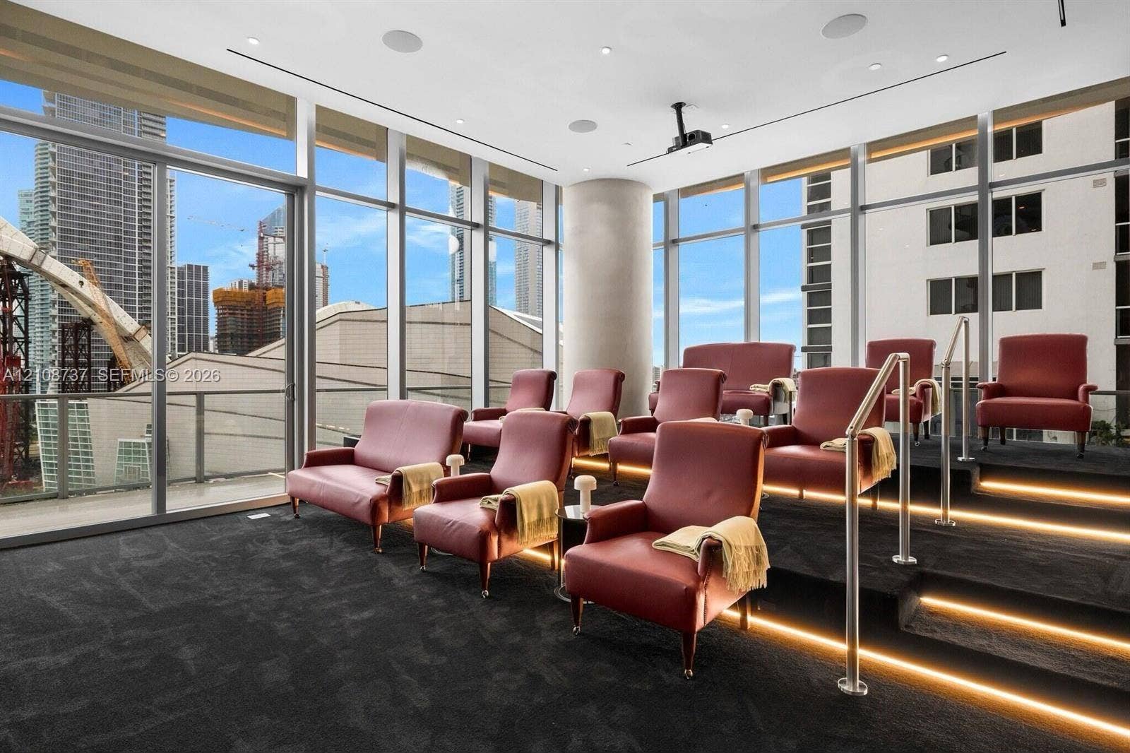 1400 Biscayne Boulevard, #3503, Miami, Miami, FL 33132 Floor-to-ceiling windows, tiered seating platform with integrated LED stair lighting, built-in ceiling projector, and recessed surround sound speakers