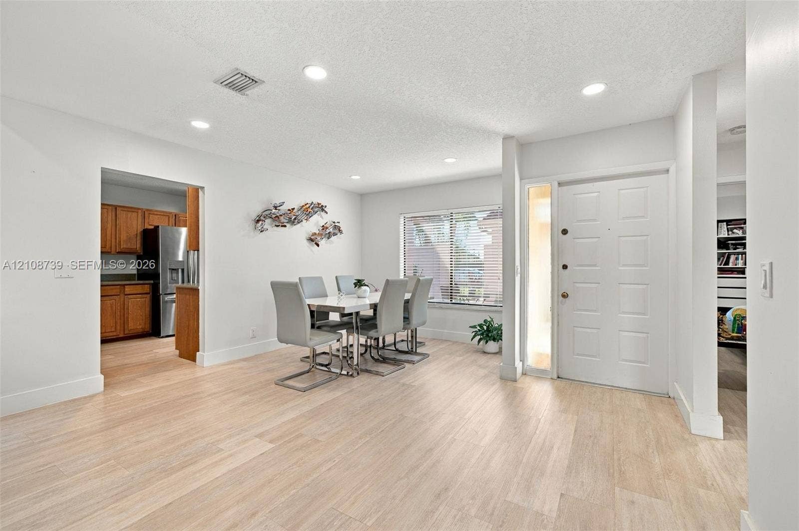 632 Village Lake Drive, Weston, FL 33326 Open-concept interior featuring light wood-finish flooring, recessed lighting, and a six-panel entry door with a side light