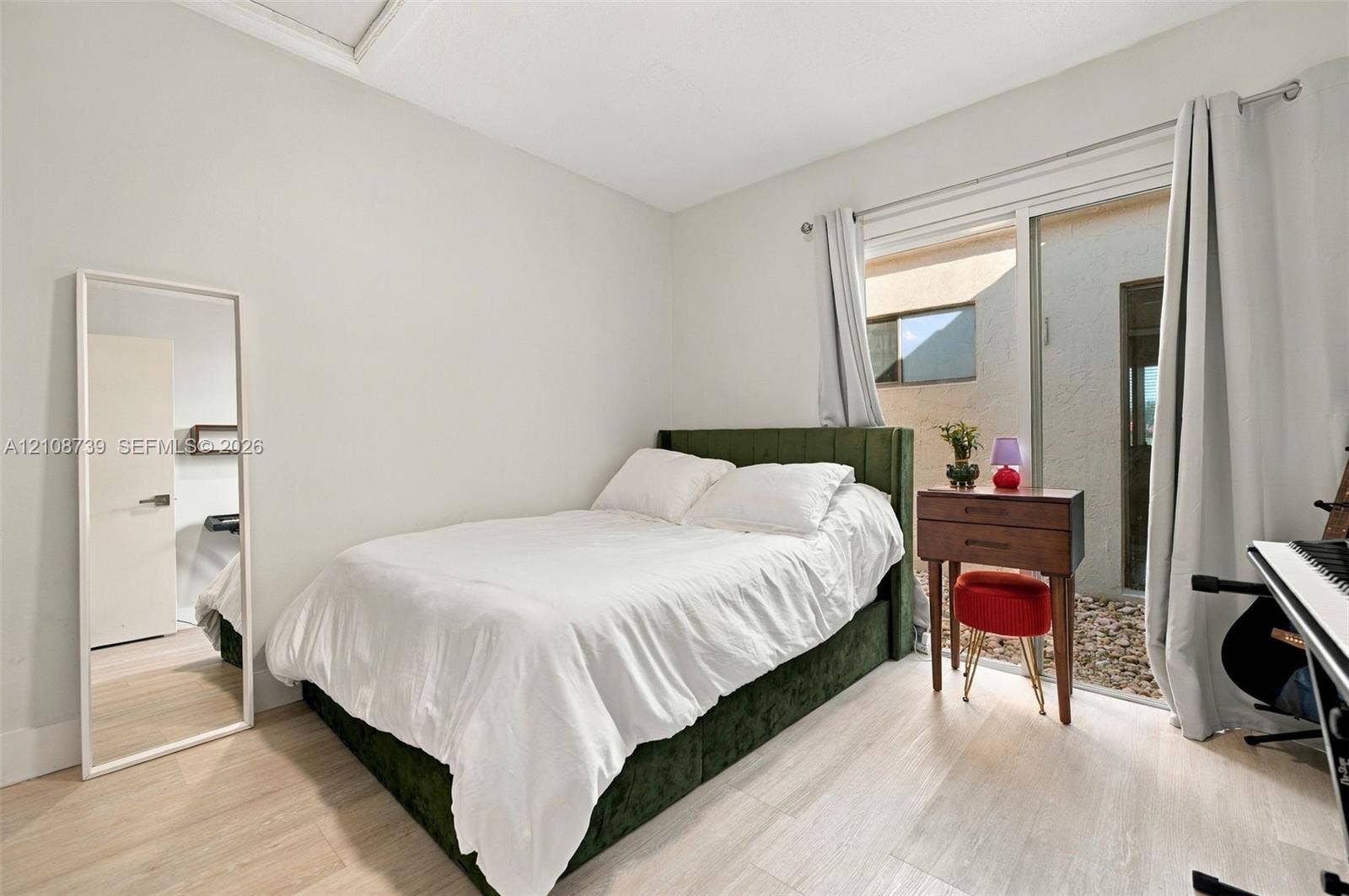 632 Village Lake Drive, Weston, FL 33326 Interior space featuring neutral wall paint, wood-finish flooring, and a large sliding glass door