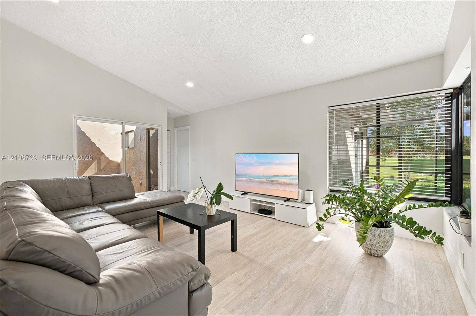 632 Village Lake Drive, Weston, FL 33326 Vaulted ceilings, wood-finish flooring, recessed lighting, and expansive windows featuring horizontal blinds