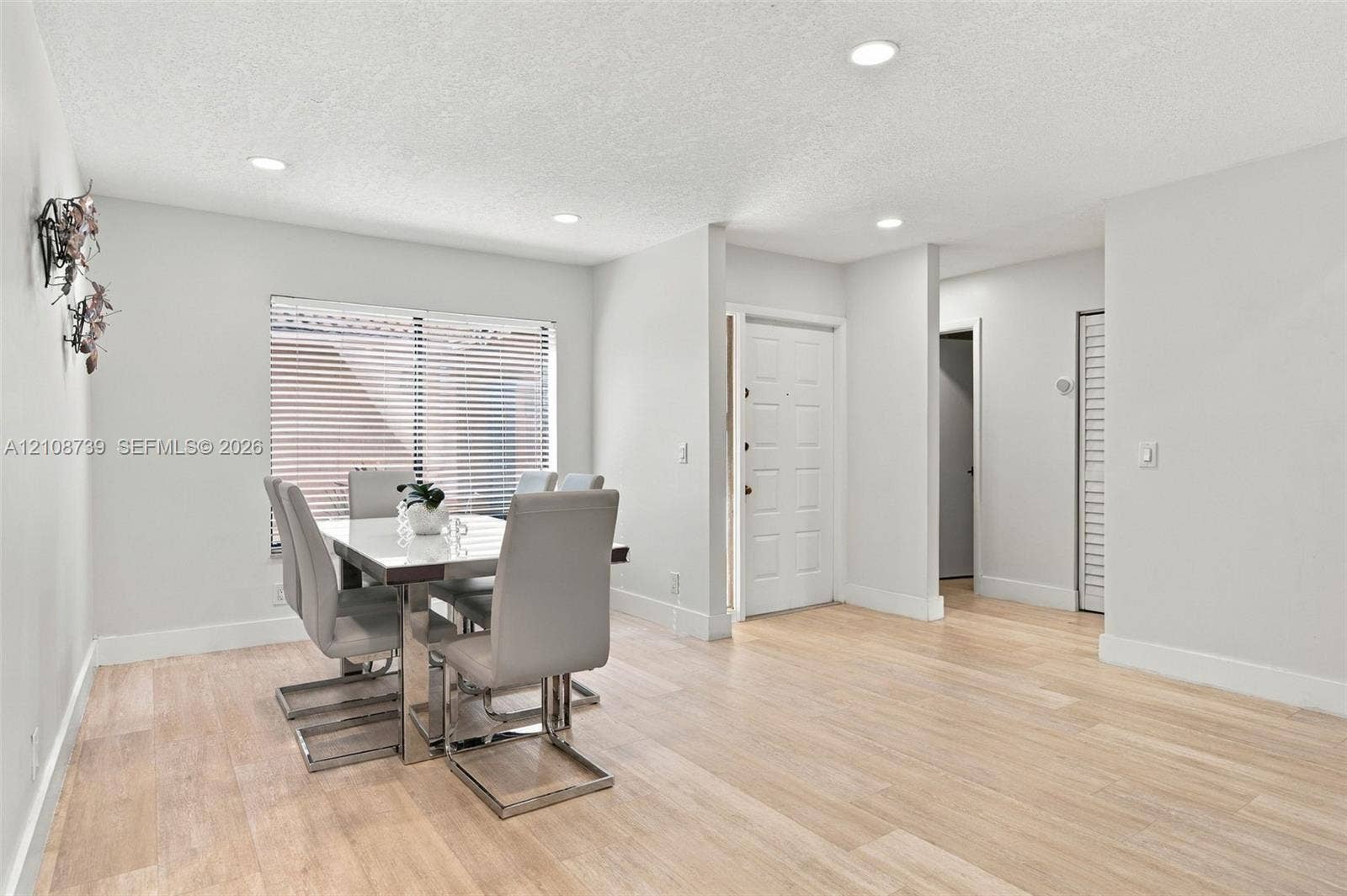 632 Village Lake Drive, Weston, FL 33326 Open living space featuring wood-finish flooring, recessed lighting, and a multi-panel entry door