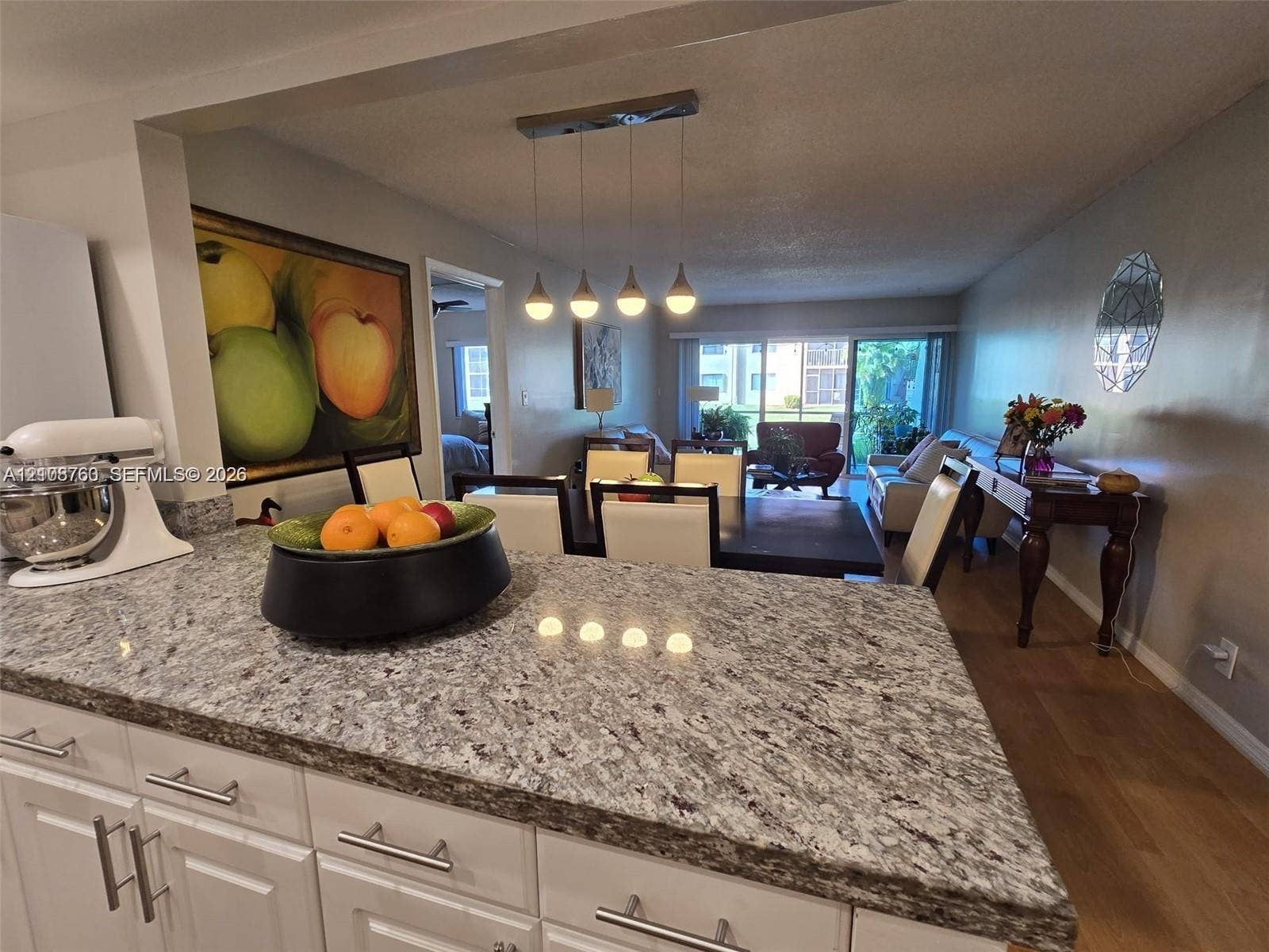 140 Lakeview Drive, #111, Weston, Weston, FL 33326 Kitchen featuring a stone-finish countertop, white cabinetry with metallic hardware, and a four-light pendant fixture
