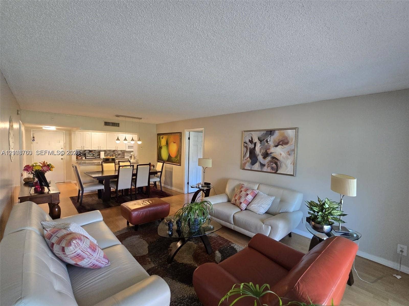 140 Lakeview Drive, #111, Weston, Weston, FL 33326 Open-concept living space featuring wood-finish flooring and white cabinetry