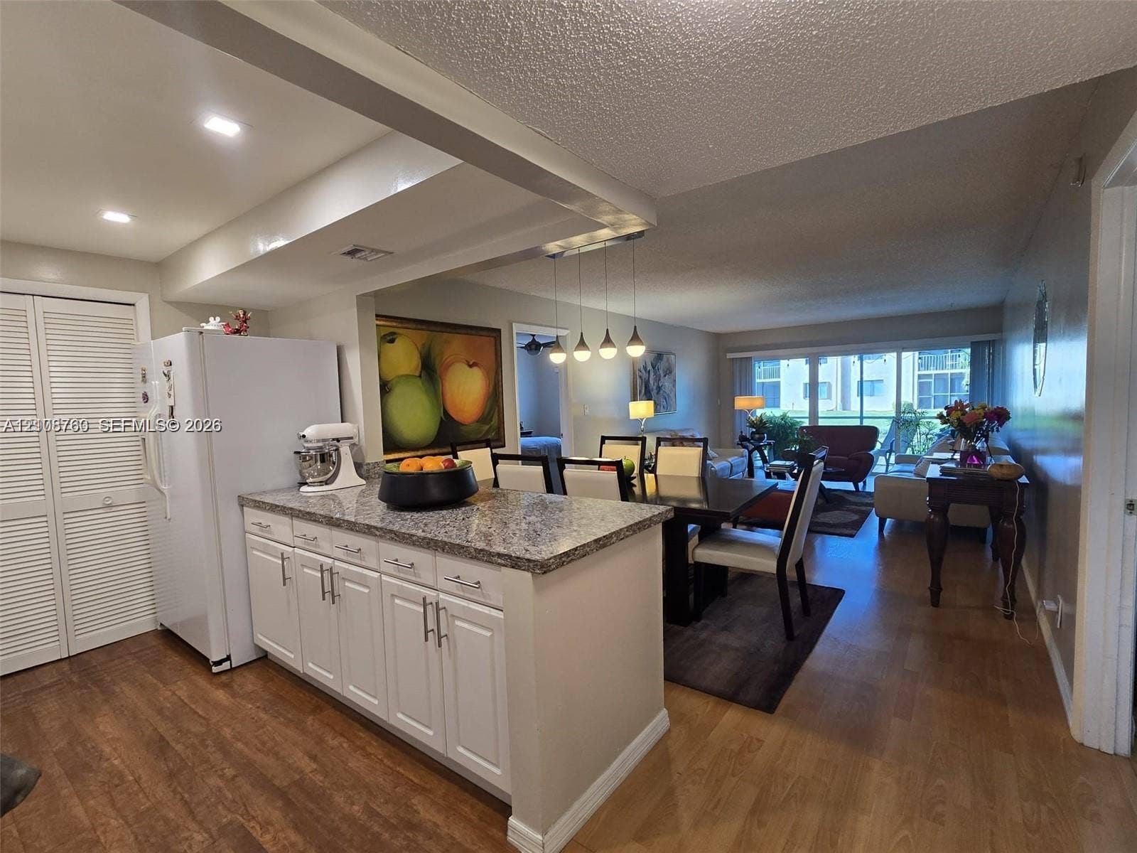 140 Lakeview Drive, #111, Weston, Weston, FL 33326 Kitchen featuring white cabinetry, stone-finish countertops, wood-finish flooring, recessed lighting, and a pendant light fixture