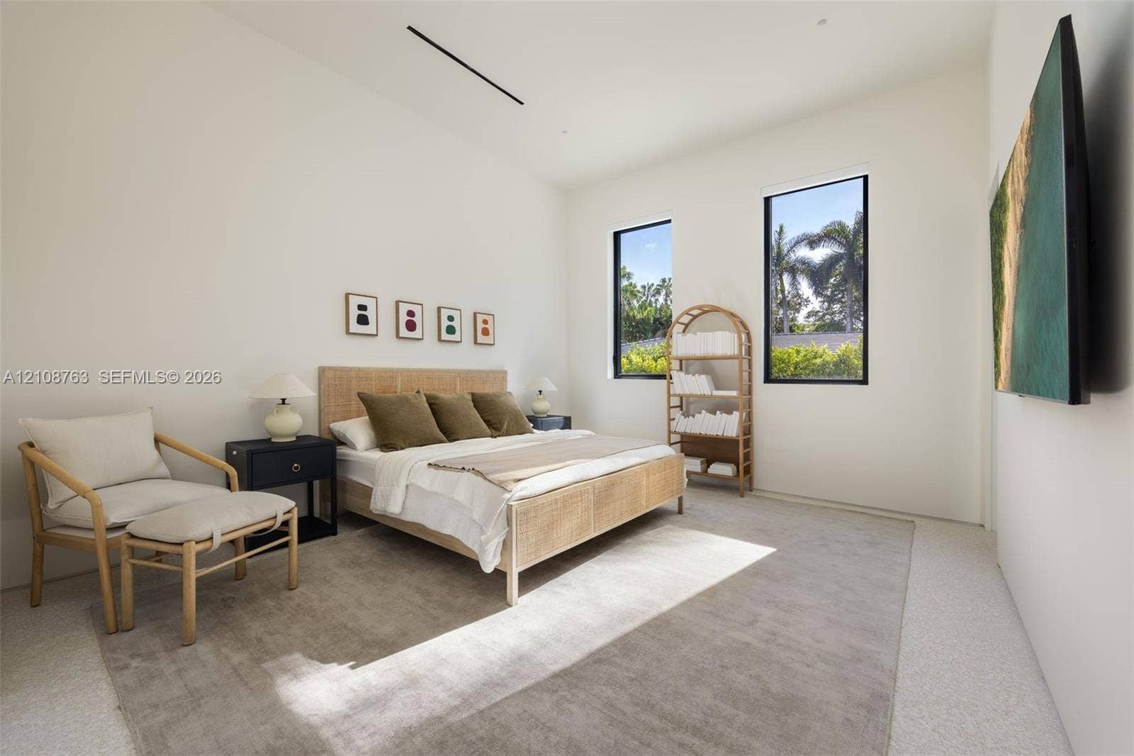 High-ceilinged room featuring recessed linear lighting, polished concrete flooring, and dual vertical windows