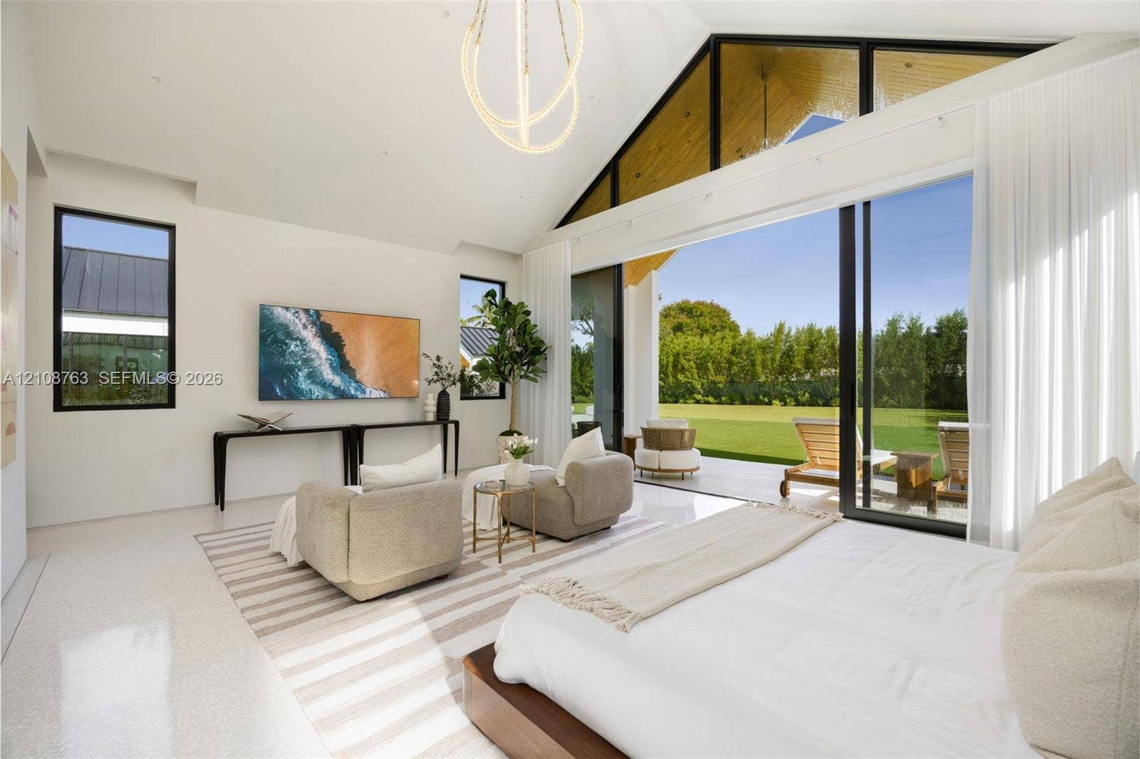 Vaulted ceilings with exposed timber detailing, expansive glass sliding walls, sleek polished flooring, and contemporary overhead lighting fixture