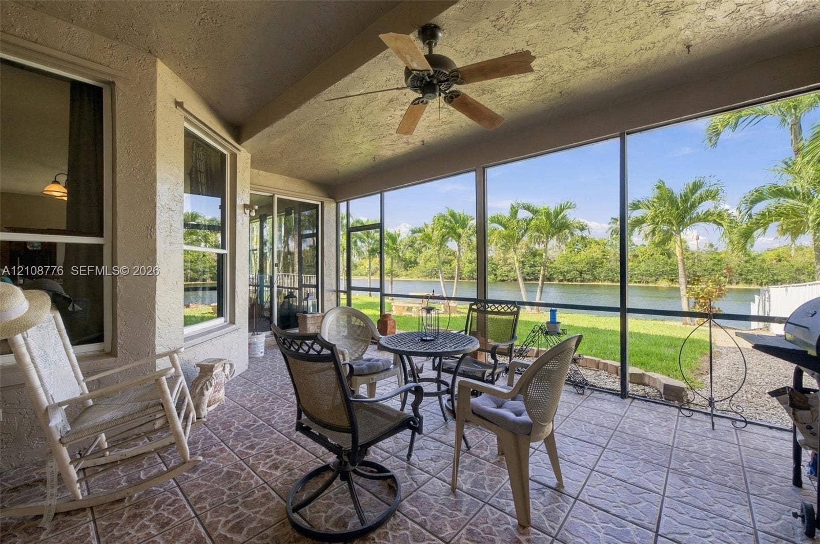 18041 SW 33rd Street, Miramar, FL 33029 Screened-in lanai featuring tiled flooring, a ceiling fan, and metal framing