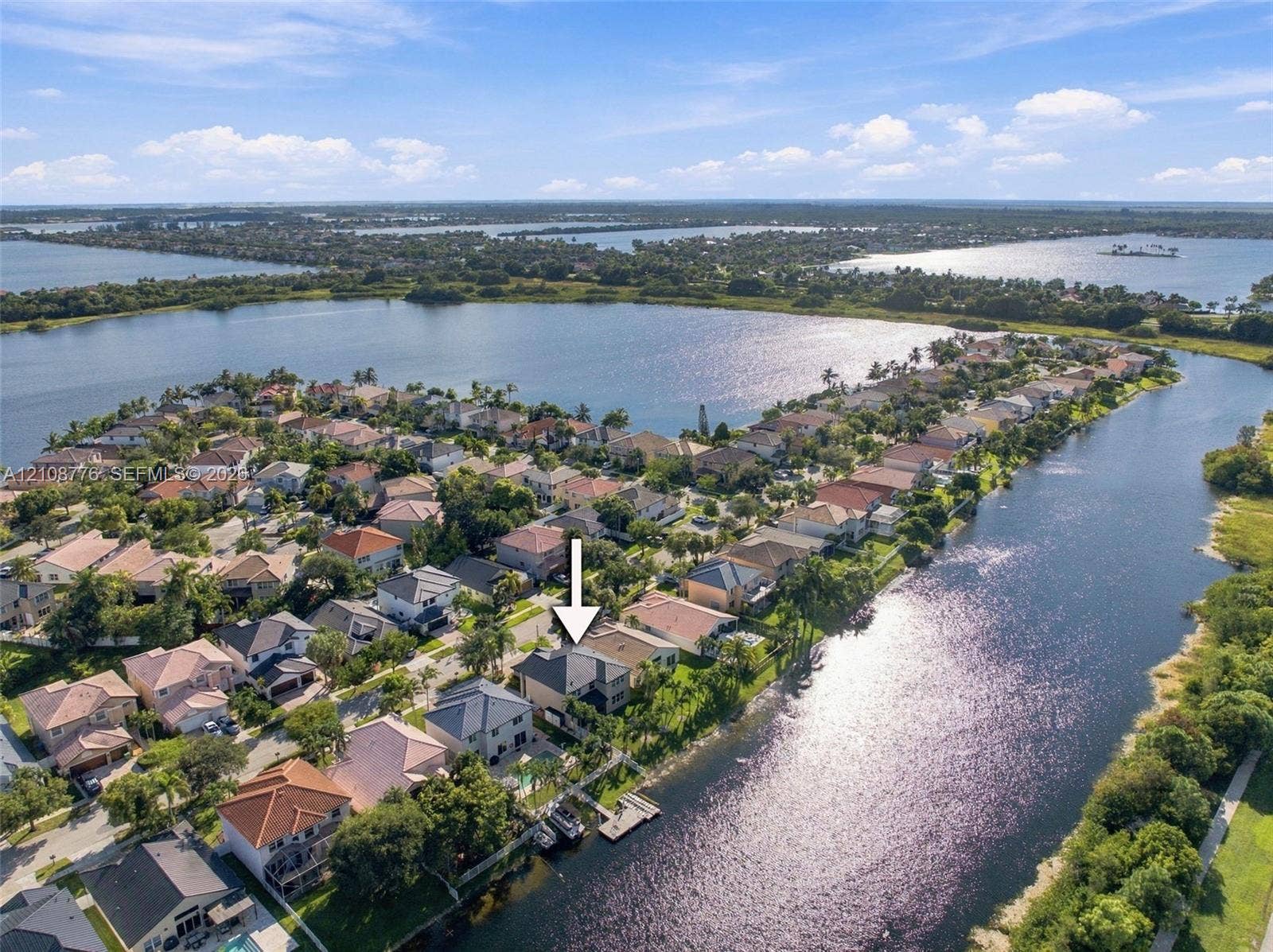 18041 SW 33rd Street, Miramar, FL 33029 Aerial perspective of a waterfront residential property featuring a private boat dock and tile roofing