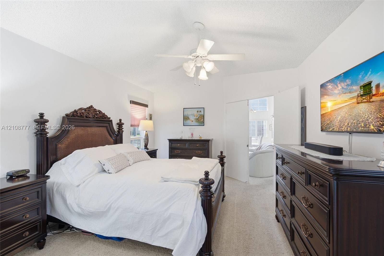 Vaulted ceiling featuring a central white lighted ceiling fan