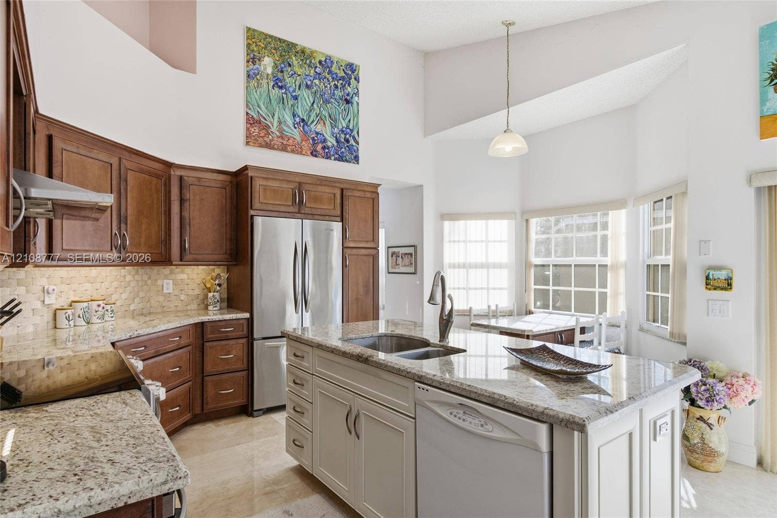 Kitchen featuring dark wood cabinetry, a central island with a stone countertop, stainless steel appliances, a tile backsplash, and a vaulted ceiling