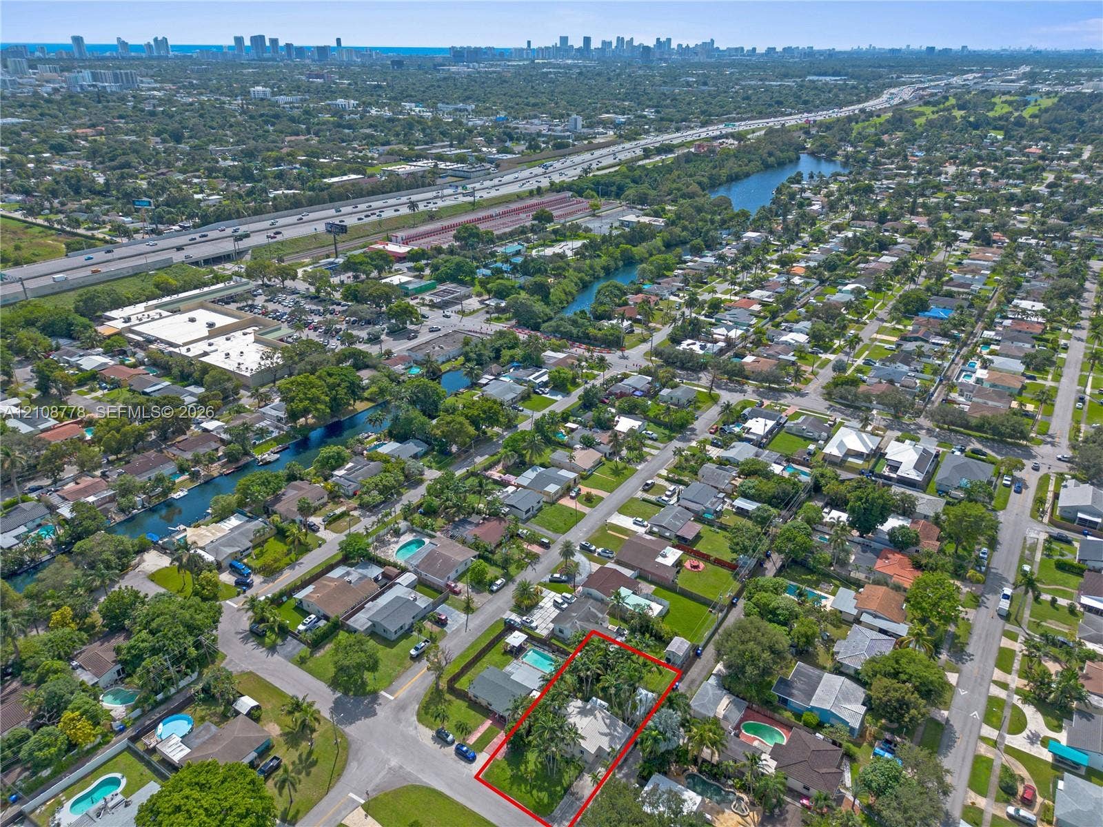 3116 Hayes Street, Hollywood, FL 33021 Aerial perspective featuring a corner lot property with mature landscaping, palm trees, and an established residential neighborhood setting
