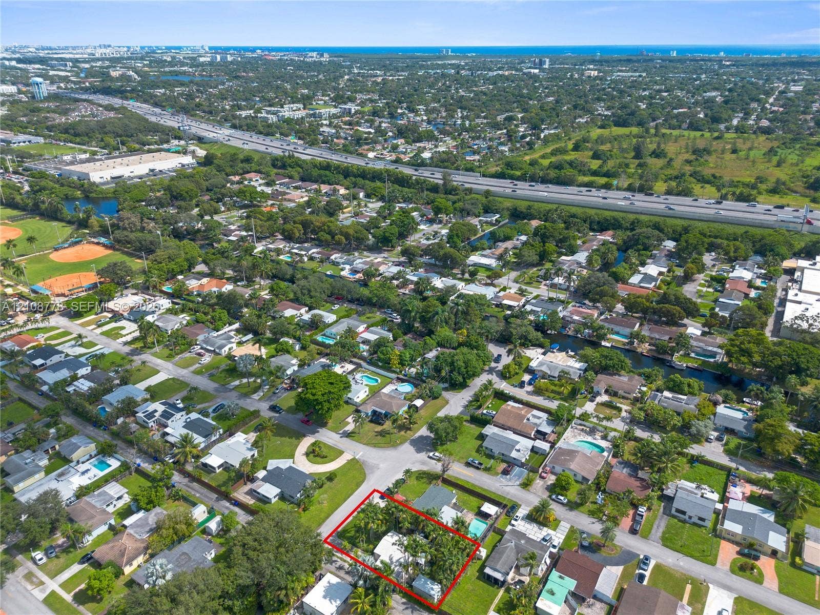 3116 Hayes Street, Hollywood, FL 33021 Aerial perspective of a corner lot property featuring mature landscaping and a perimeter boundary line