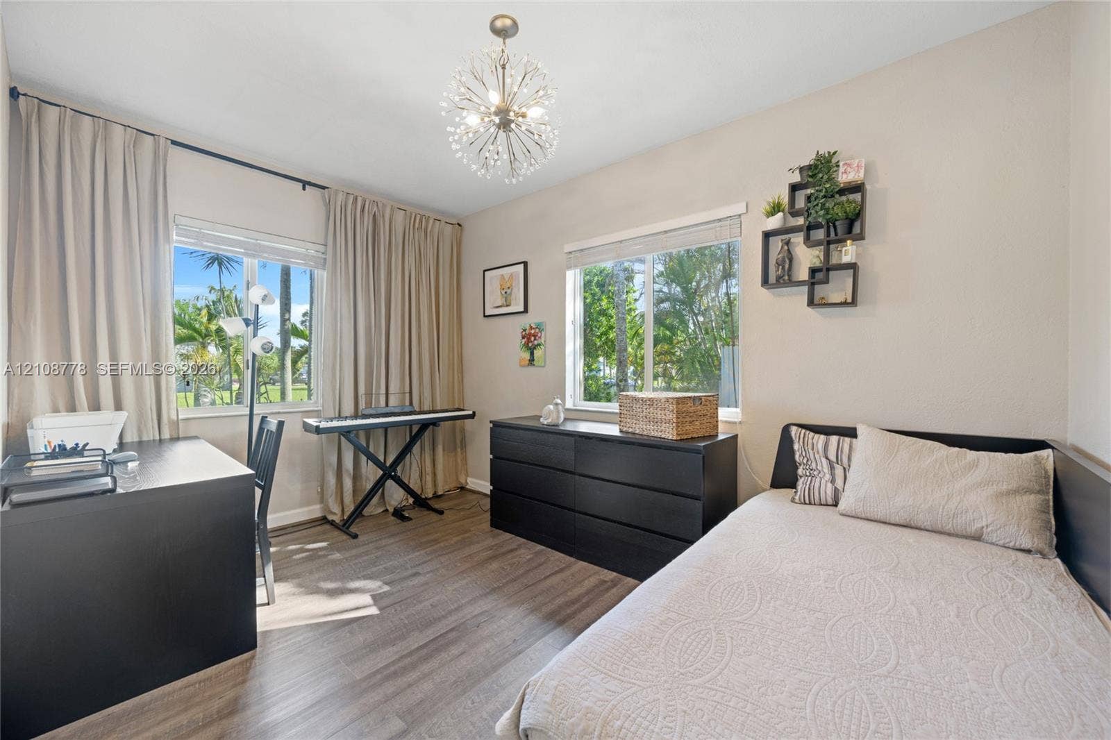 3116 Hayes Street, Hollywood, FL 33021 Wood-finish flooring, dual windows with exterior palm tree scenery, and a contemporary multi-arm spherical ceiling fixture