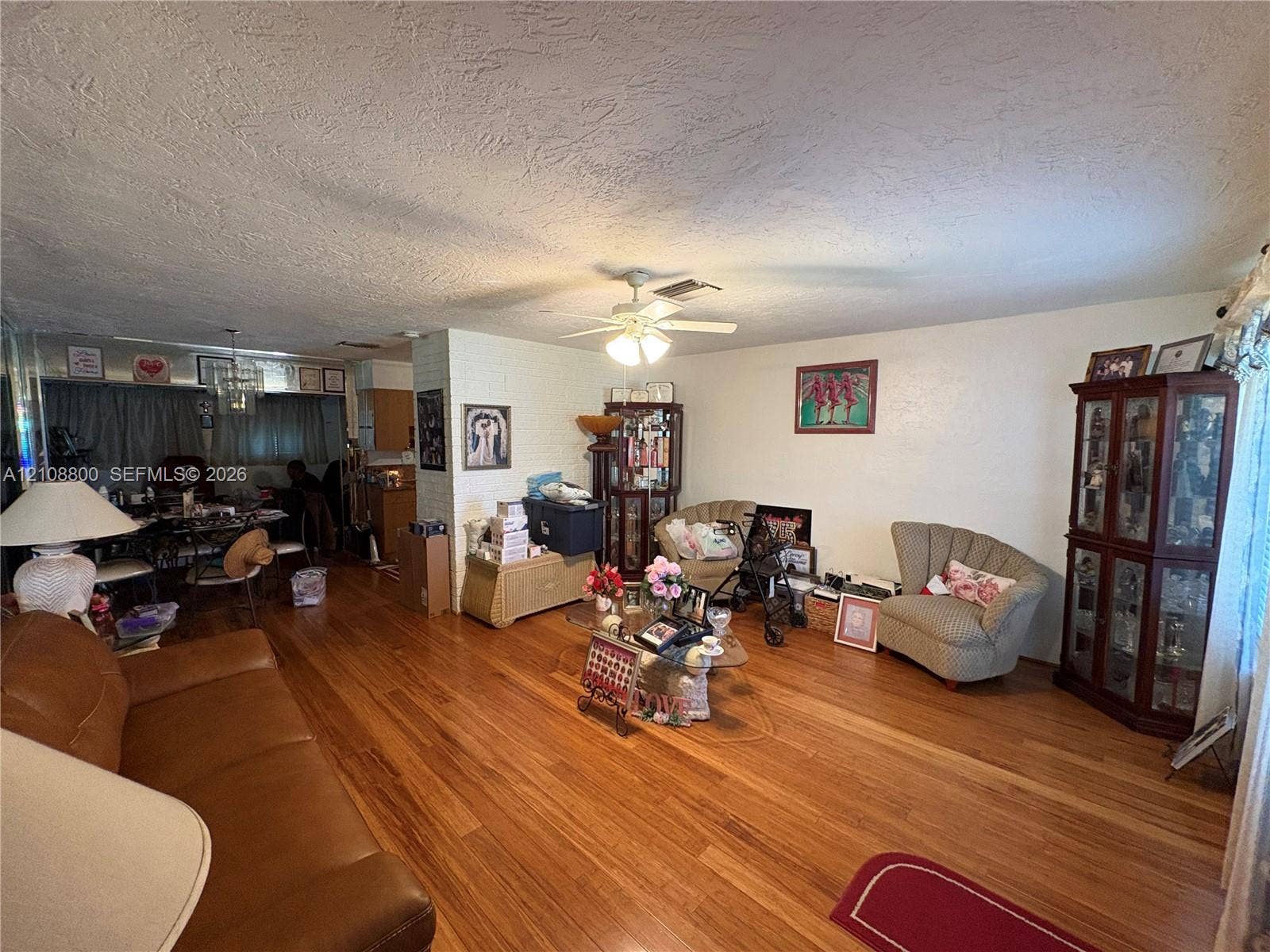 451 SW 30th Avenue, Fort Lauderdale, FL 33312 Living area featuring wood-finish flooring, a ceiling fan, and a textured ceiling finish