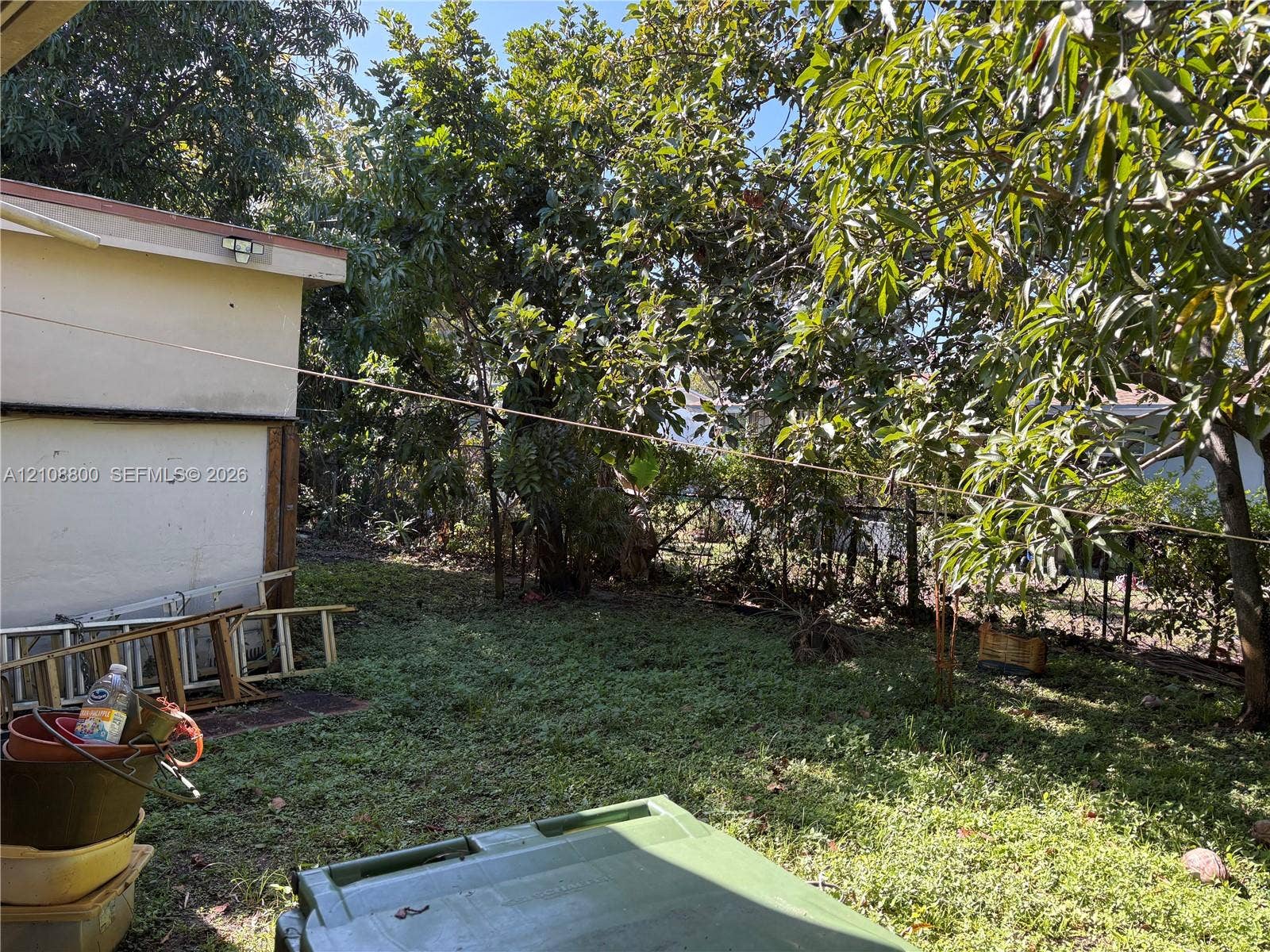 451 SW 30th Avenue, Fort Lauderdale, FL 33312 Exterior space featuring mature trees and a grass-covered lot