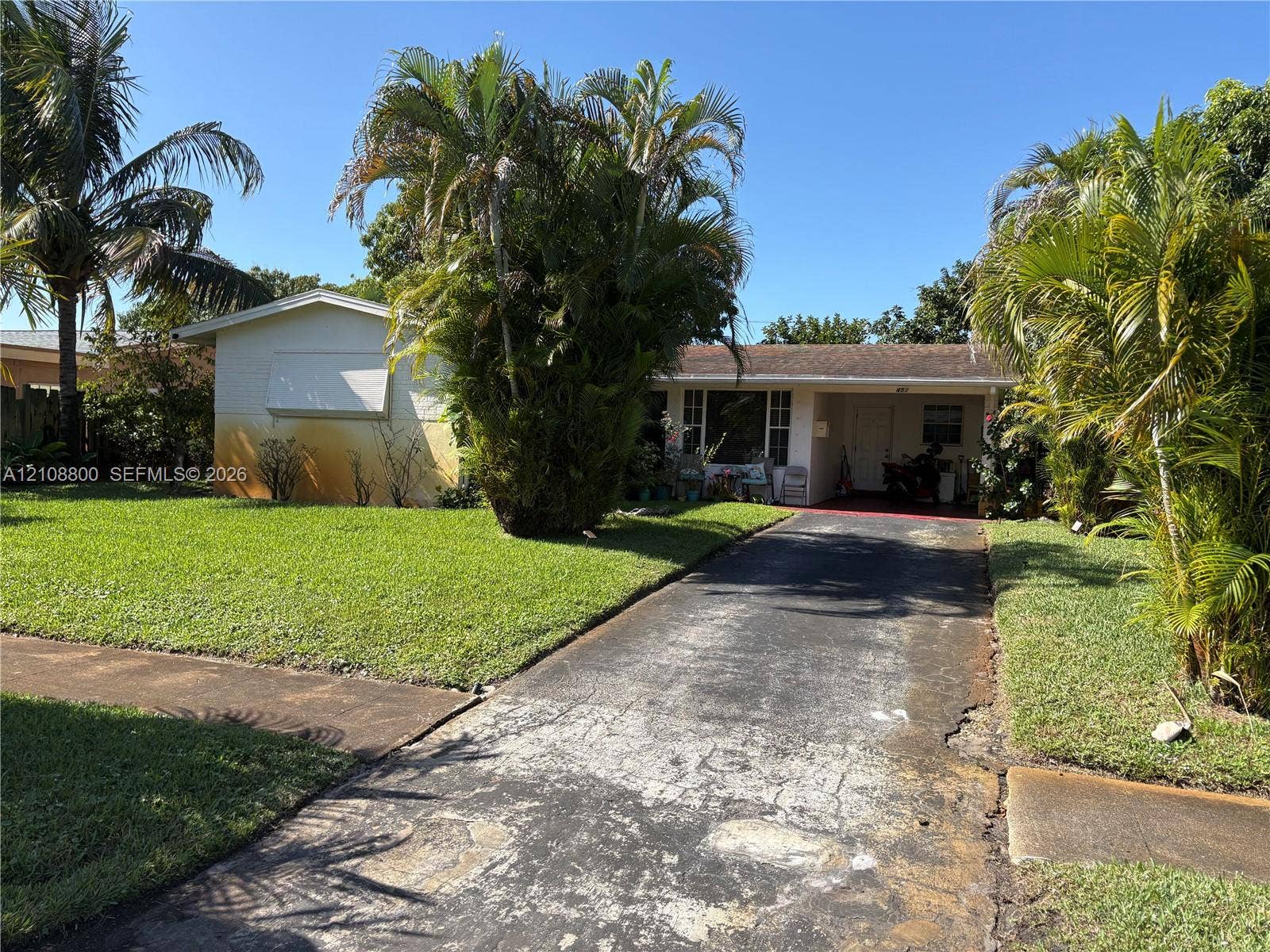 451 SW 30th Avenue, Fort Lauderdale, FL 33312 Single-story exterior featuring a covered front entry, asphalt driveway, and mature landscaping