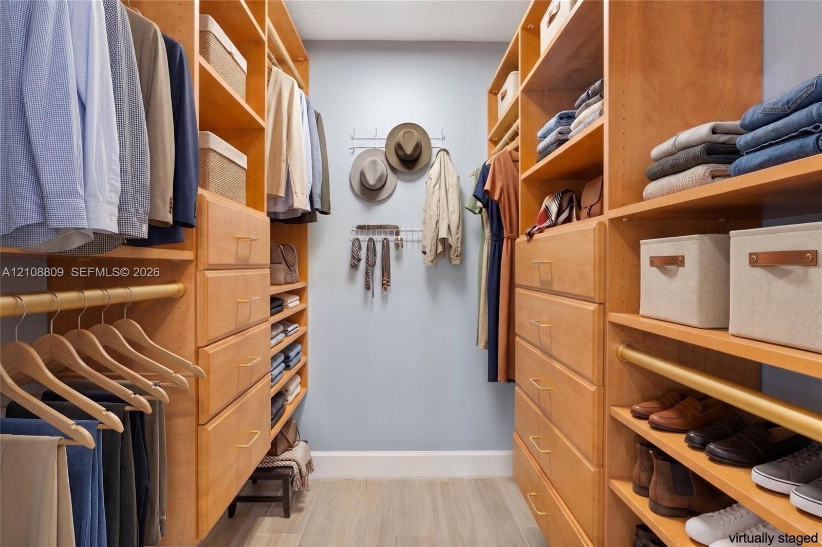 Custom walk-in closet featuring floor-to-ceiling wooden shelving, integrated dresser drawers, multi-level hanging rods, and open shoe storage