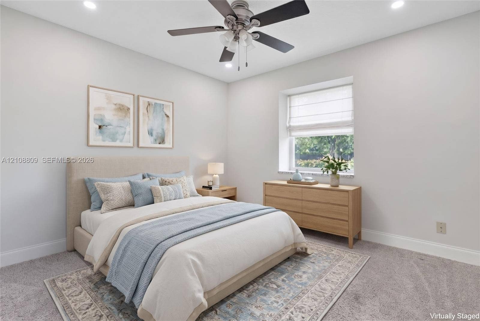 Neutral-toned interior featuring wall-to-wall carpeting, recessed ceiling lighting, and a multi-blade ceiling fan with integrated light fixture