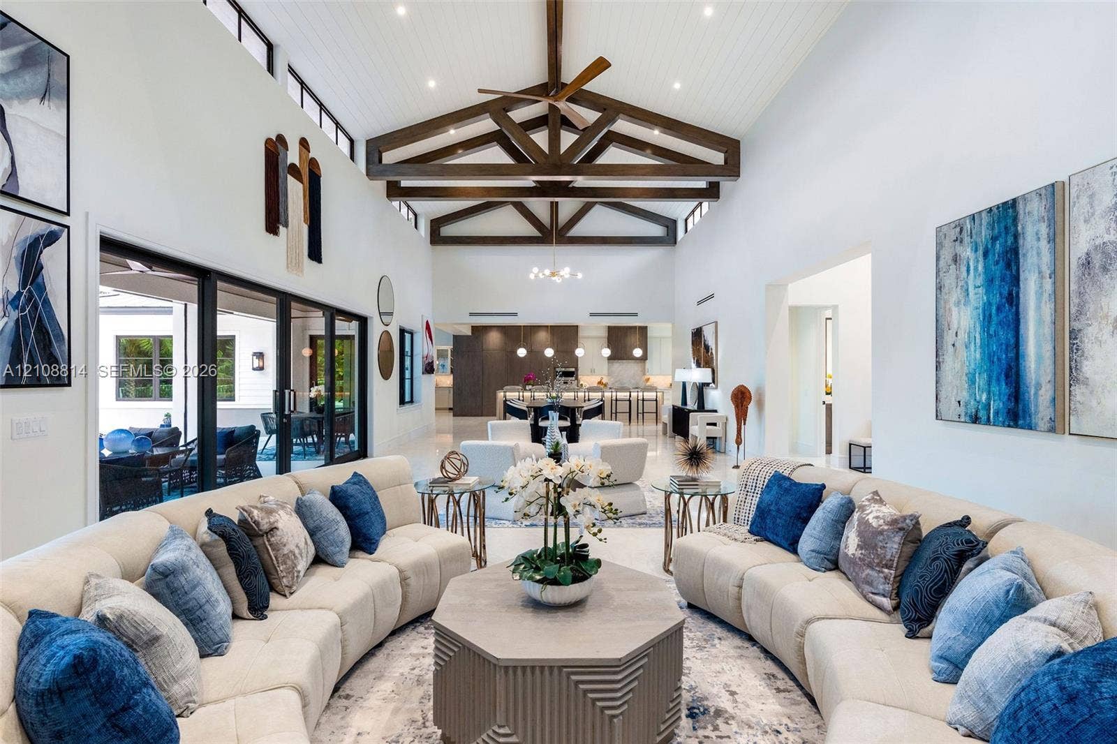 Vaulted ceilings with exposed decorative timber trusses and beadboard paneling, clerestory windows, and large-format tile flooring
