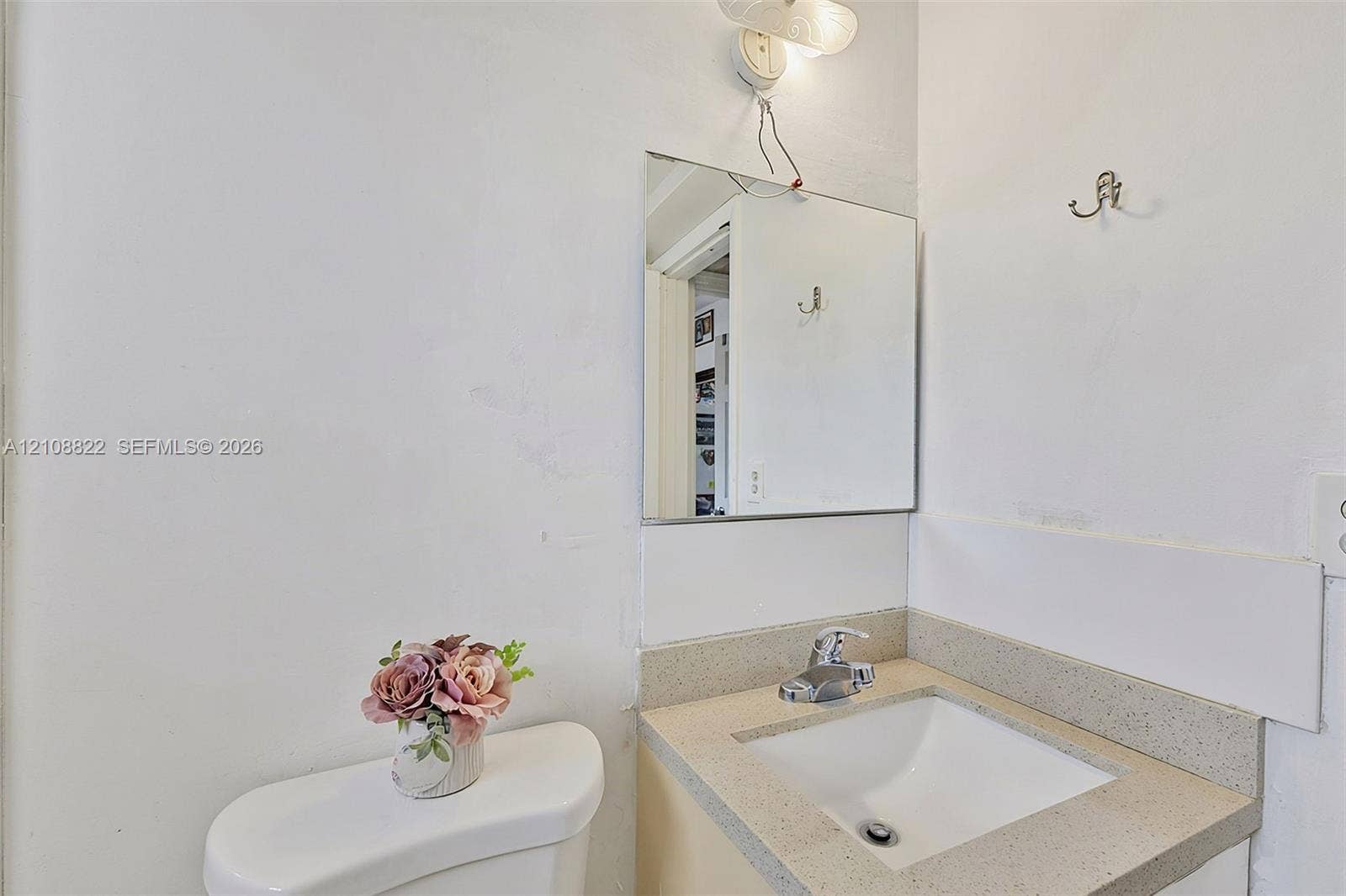 6838 SW 22nd Court, Miramar, FL 33023 Wall-mounted mirror, vanity with a light-toned countertop, and integrated sink with a polished metal faucet