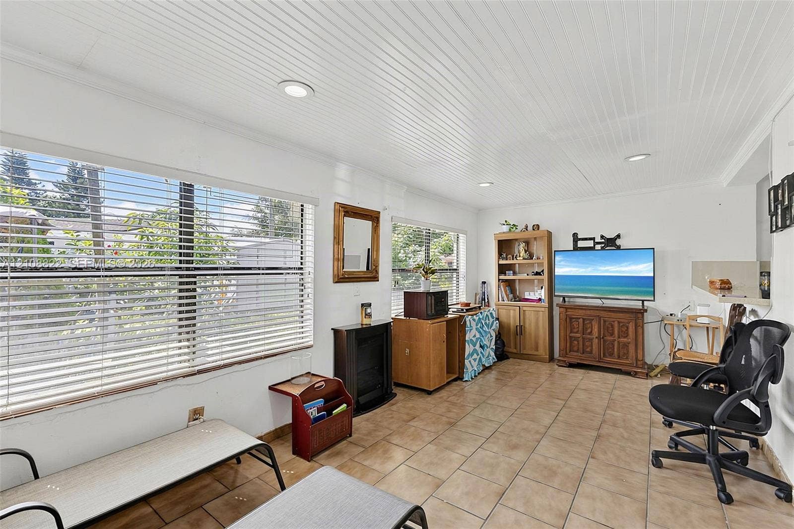 6838 SW 22nd Court, Miramar, FL 33023 Beadboard ceiling with recessed lighting, large windows with horizontal blinds, and ceramic tile flooring