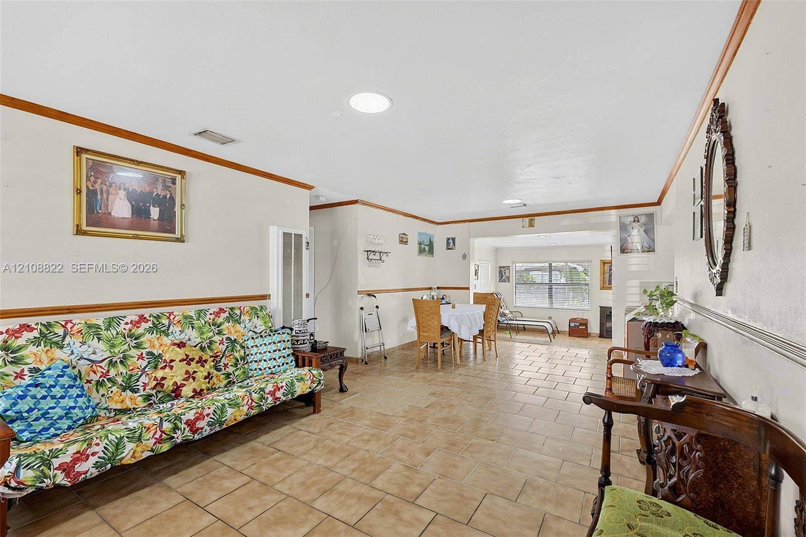 6838 SW 22nd Court, Miramar, FL 33023 Open-concept interior featuring light-toned tile flooring, chair rail molding, and recessed ceiling lighting