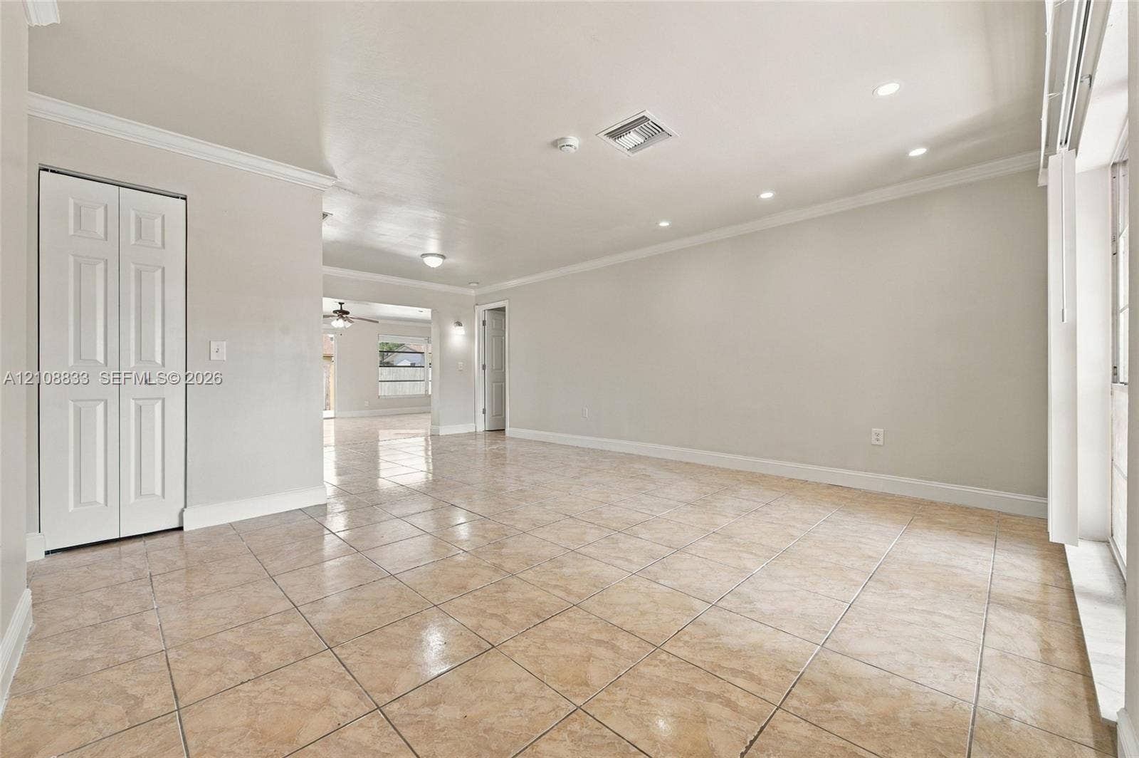 9611 Johnson Street, Pembroke Pines, FL 33024 Interior room featuring neutral wall paint, recessed lighting, crown molding, tile flooring, and a closet with paneled doors