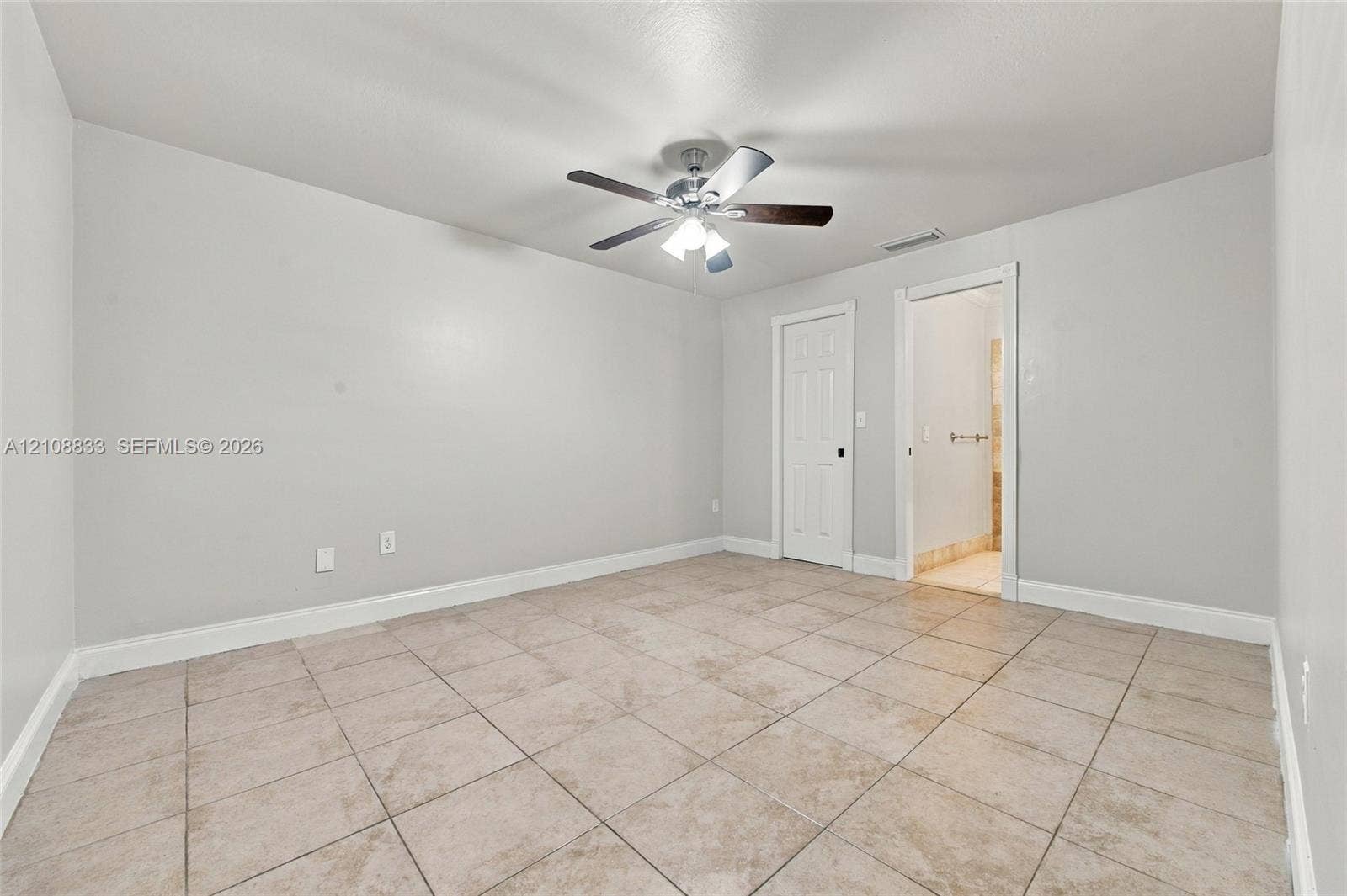 9611 Johnson Street, Pembroke Pines, FL 33024 Room featuring large-format ceramic floor tile, neutral wall paint, and a ceiling-mounted light fixture with a multi-blade fan