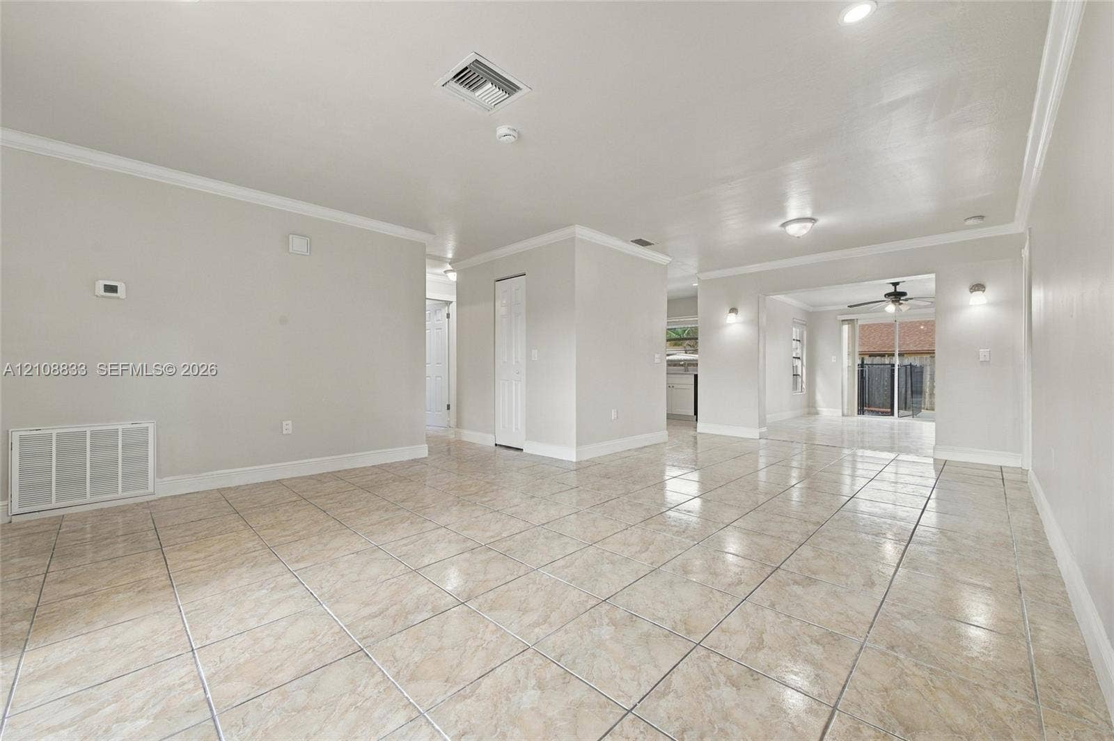 9611 Johnson Street, Pembroke Pines, FL 33024 Interior space featuring neutral wall paint, tile flooring, recessed ceiling lighting, and crown molding