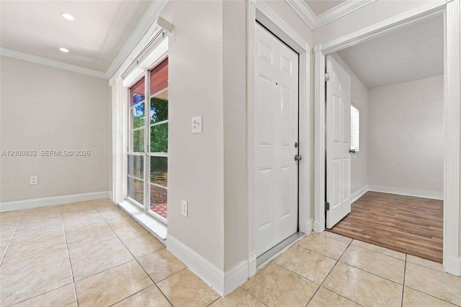 9611 Johnson Street, Pembroke Pines, FL 33024 Interior space featuring ceramic tile flooring, recessed lighting, crown molding, sliding glass patio door, and wood-finish flooring