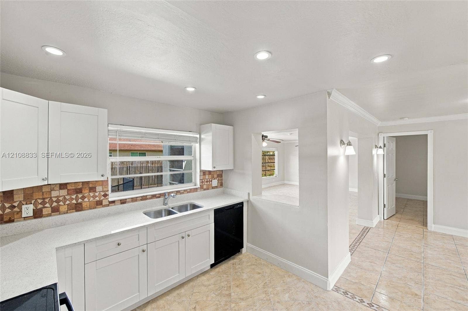 9611 Johnson Street, Pembroke Pines, FL 33024 Kitchen featuring white cabinetry, solid-surface countertops, mosaic tile backsplash, recessed lighting, and tile flooring