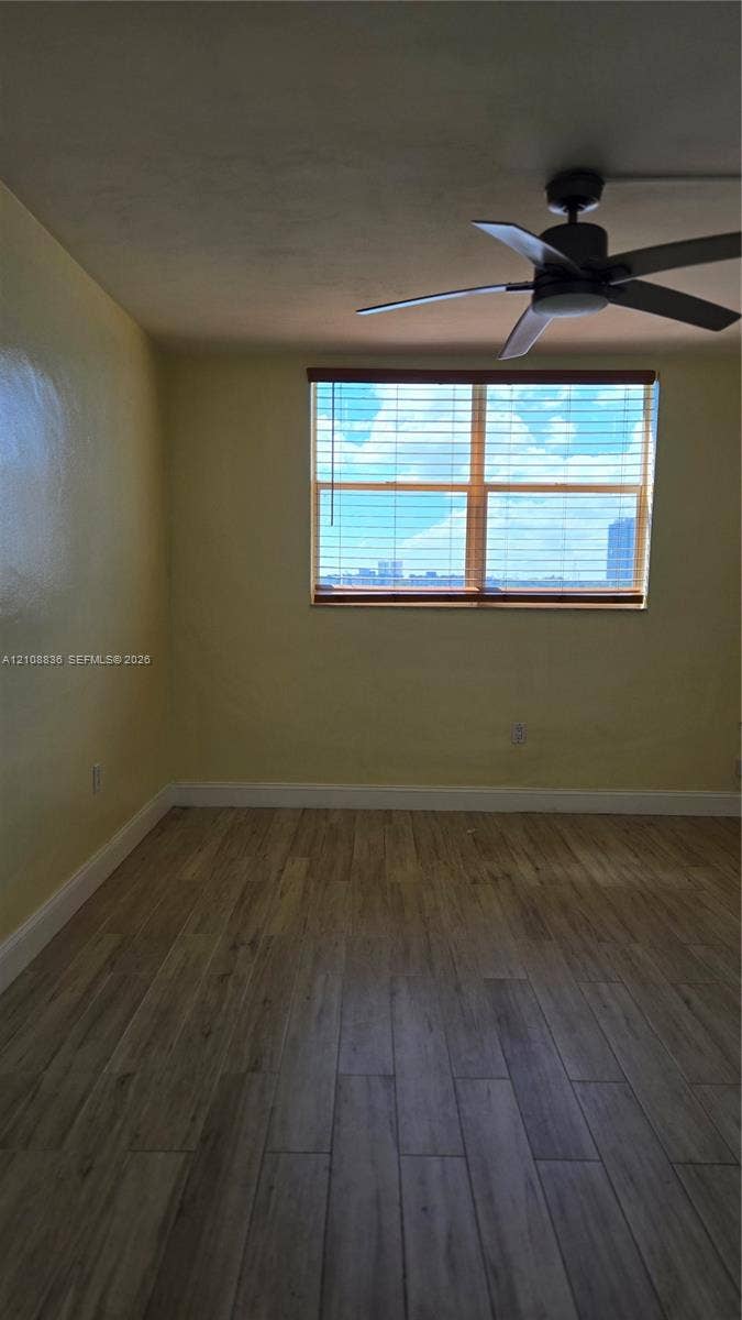 3000 Marcos Drive, #P304, Aventura, FL 33160 Wood-finish flooring, multi-pane window with blinds, and ceiling fan with integrated light fixture