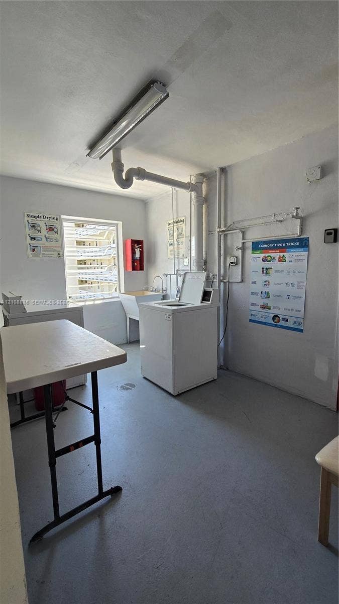 3000 Marcos Drive, #P304, Aventura, FL 33160 Utility area featuring an integrated wash basin, exposed industrial-style lighting, and a window providing natural light