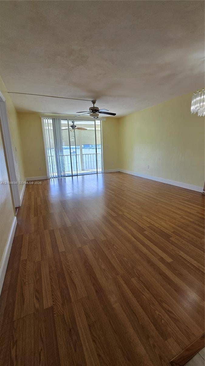 3000 Marcos Drive, #P304, Aventura, FL 33160 Wood-finish flooring, ceiling fan, sliding glass door, and crystal-style chandelier