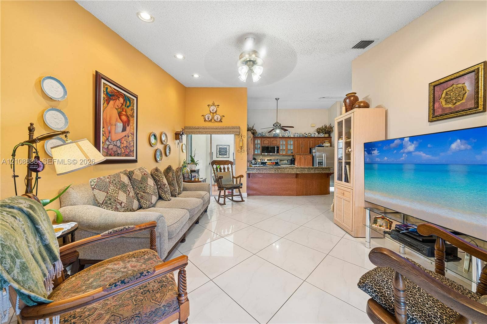 Vaulted ceilings, large-format tile flooring, recessed lighting, and a breakfast bar