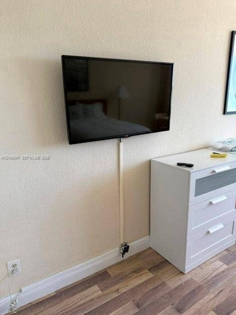 Wall-mounted display featuring wood-finish flooring