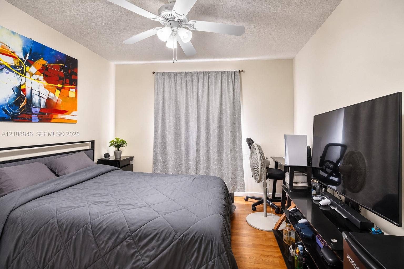 11827 SW 99th Lane, Miami, FL 33186 Room featuring wood-finish flooring, a ceiling fan with integrated lighting, and neutral wall tones
