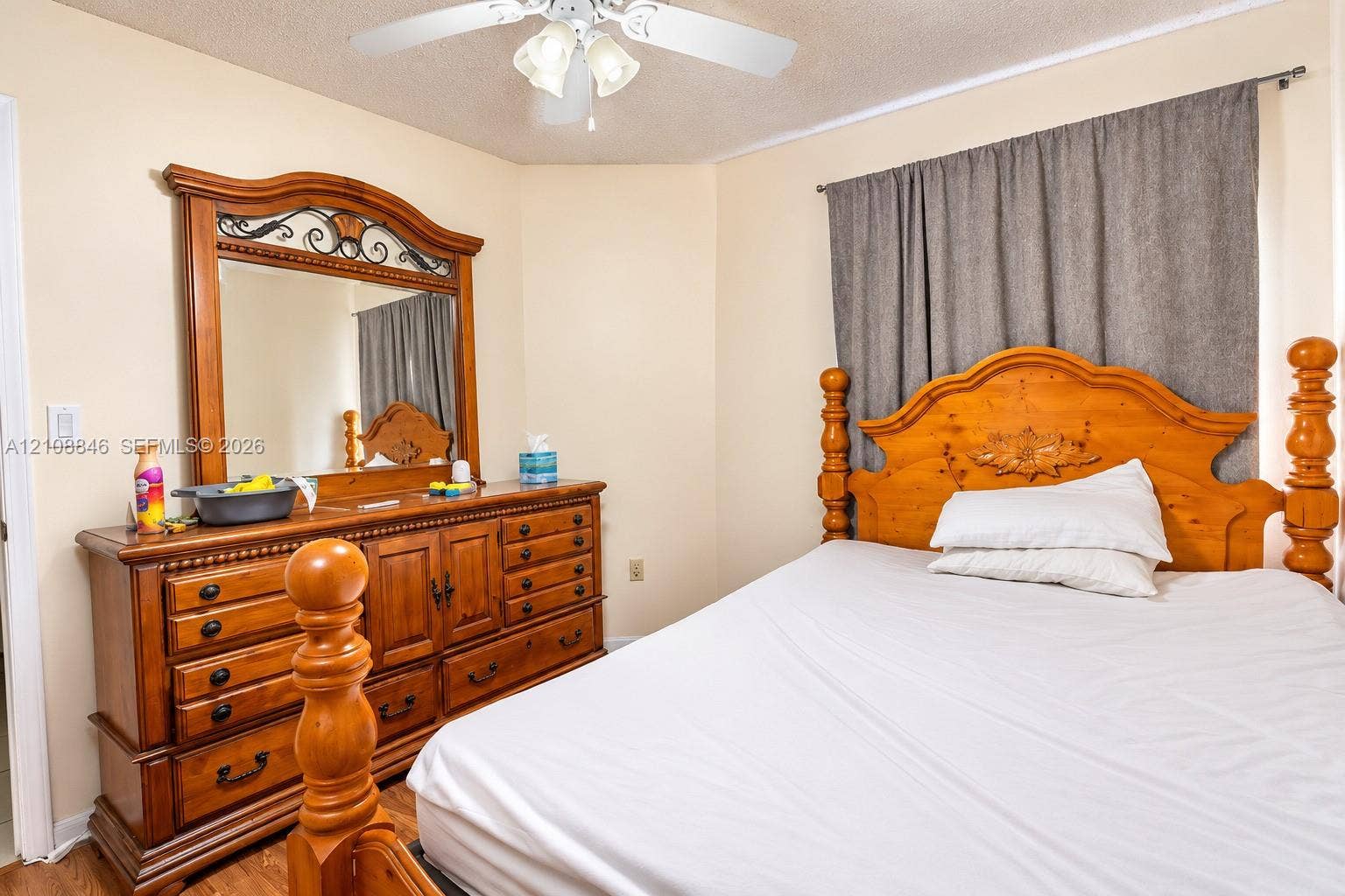 11827 SW 99th Lane, Miami, FL 33186 White ceiling fan with integrated three-light fixture and wood-finish flooring