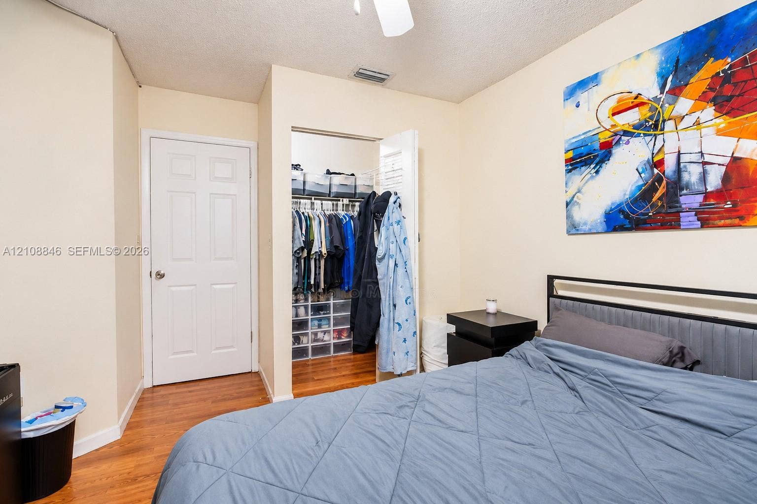 11827 SW 99th Lane, Miami, FL 33186 Room featuring wood-finish flooring and a walk-in closet with integrated wire shelving