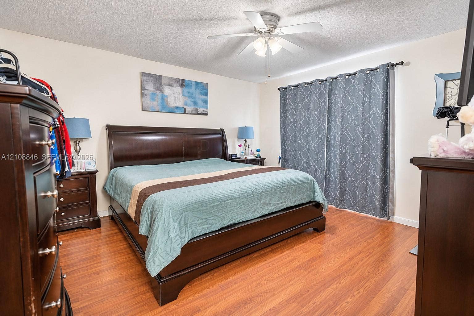 11827 SW 99th Lane, Miami, FL 33186 Bedroom featuring wood-finish flooring and a central ceiling fan with integrated lighting