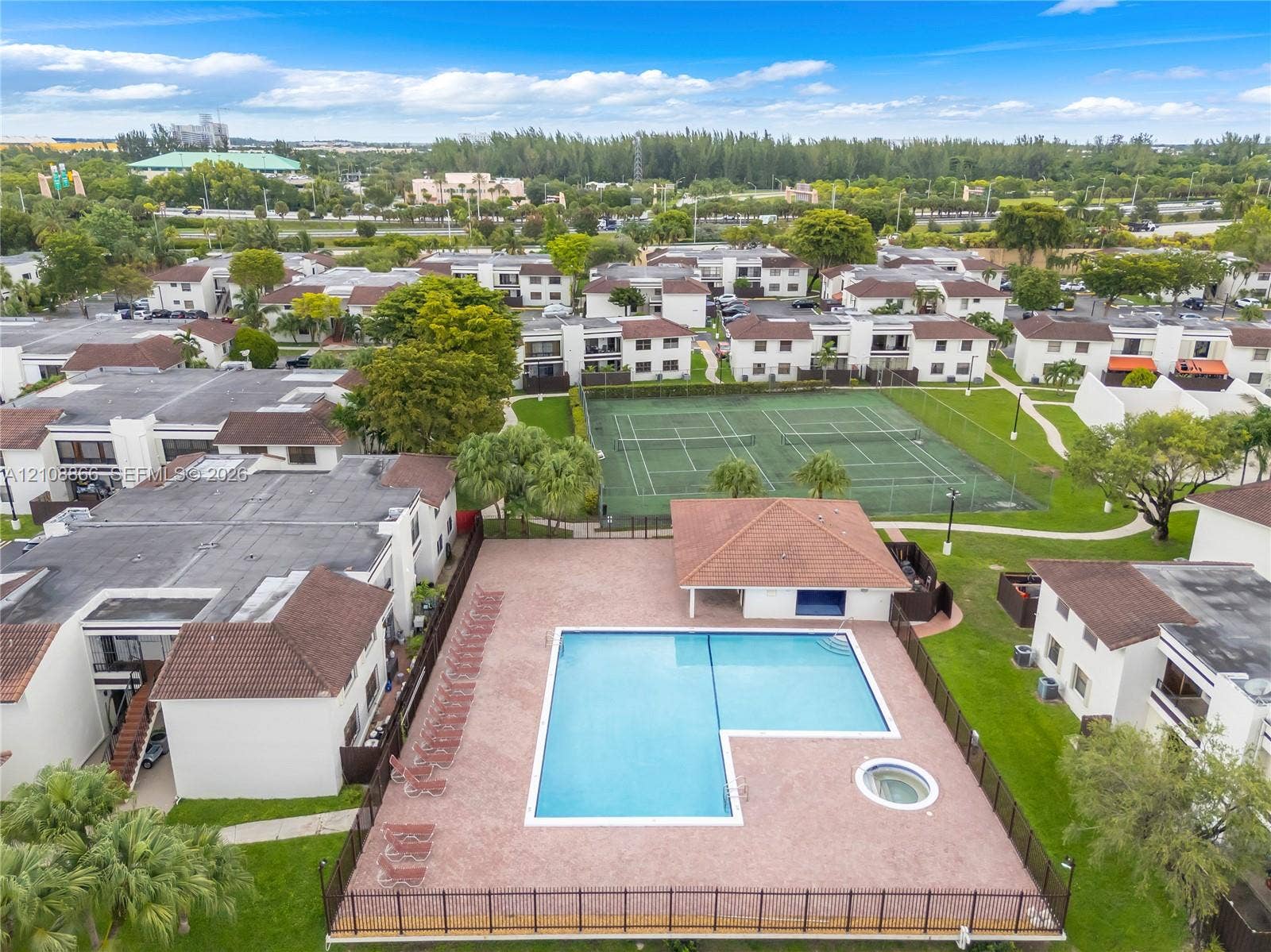 10859 NW 7th Street, #21-18, Miami, FL 33172 Community recreation area featuring a swimming pool, integrated spa, covered pavilion, and multi-court tennis facility