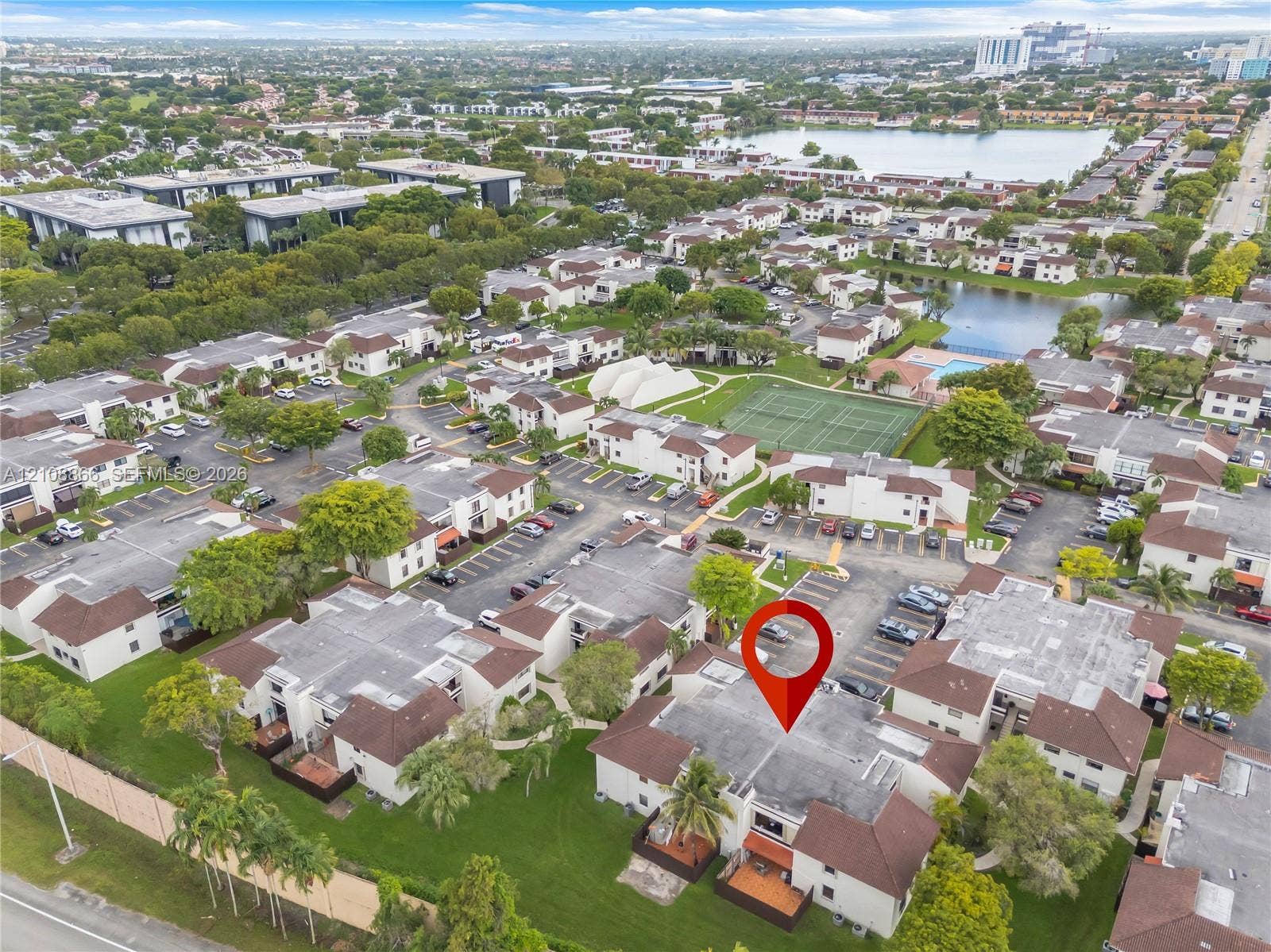 10859 NW 7th Street, #21-18, Miami, FL 33172 Aerial perspective of multi-unit residential property featuring low-rise architectural design, proximity to community tennis courts, and landscaped green space
