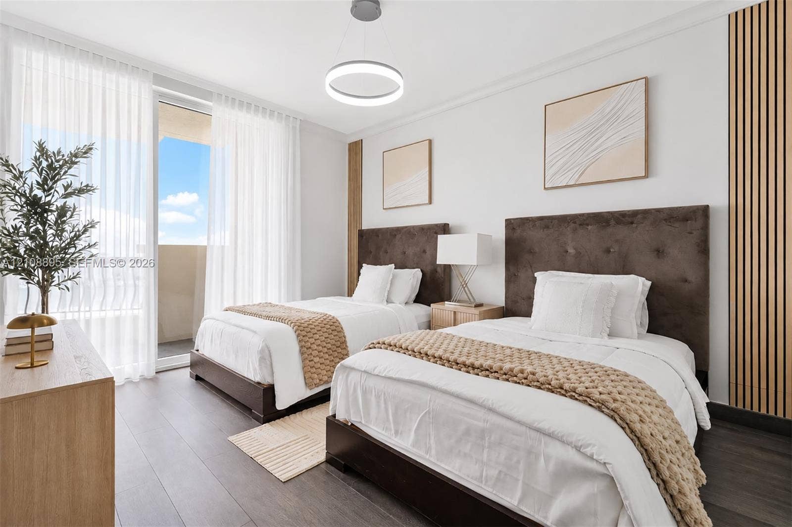 Room featuring wood-finish flooring, floor-to-ceiling glass door, circular pendant lighting, and decorative vertical wall slats