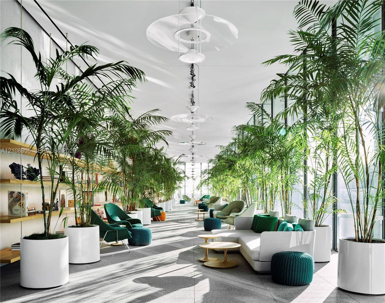 Expansive space featuring floor-to-ceiling glass walls, minimalist linear built-in shelving, suspended contemporary tiered lighting fixtures, and stone-finish flooring